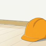 朝の光が入る室内のすみの床に置かれた、オレンジ色の作業用ヘルメット